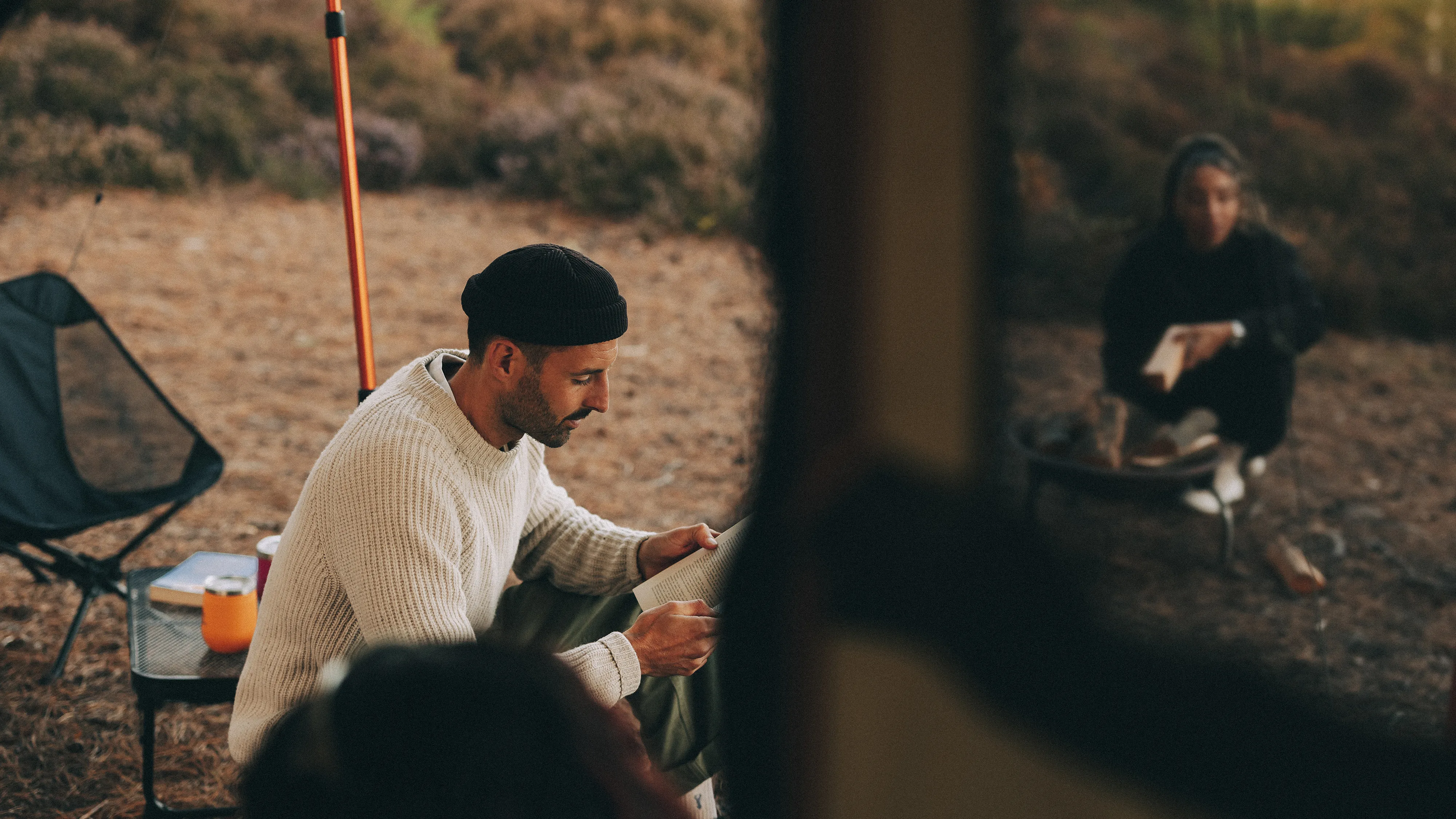 A man reading by a Kampa tent
